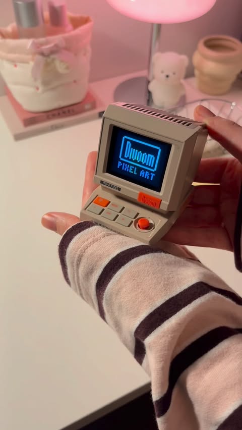 Instagram post by @esmagac_ for Divoom. Caption reads: Divoom MiniToo Retro Pixel Bluetooth Speaker 👾💗....