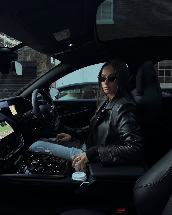 Instagram post by an influencer for Aston Martin. Caption reads: V8 coffee run @astonmartin AD.
