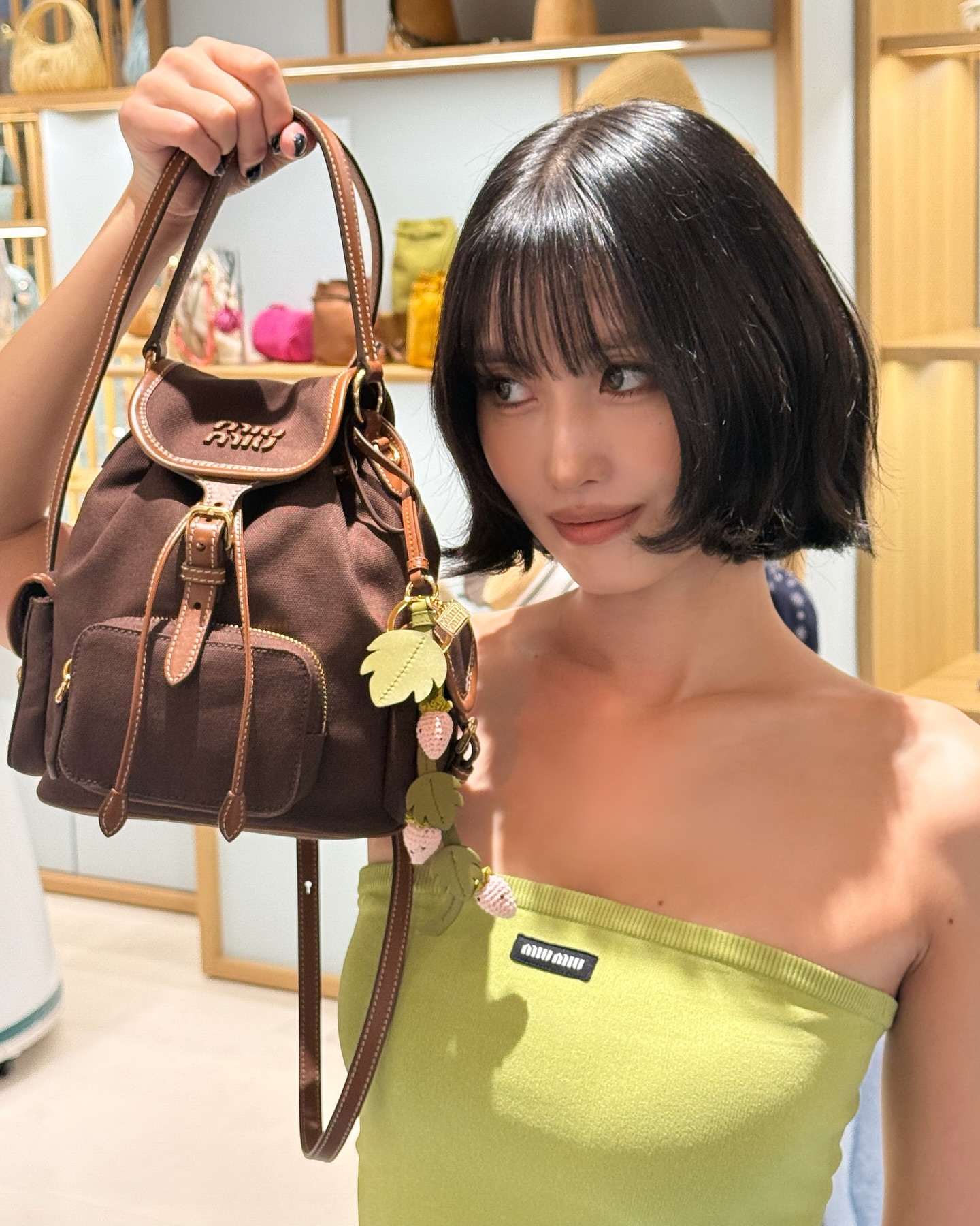 Instagram post by @momo for Miu Miu. Caption reads: ミュウミュウ....