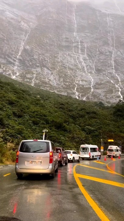 Instagram post by @worldzexplore for EARTH OFFICIAL. Caption reads: Milford Sound, New Zealand 🇳🇿: a majestic fjord....