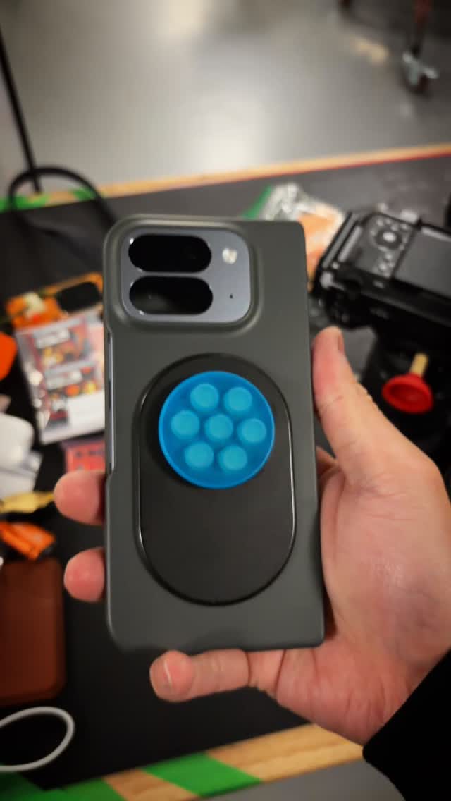 Instagram post by @excessorize.me for PopSockets. Caption reads: New phone? Yeah. New fidget toy? Also yes.....