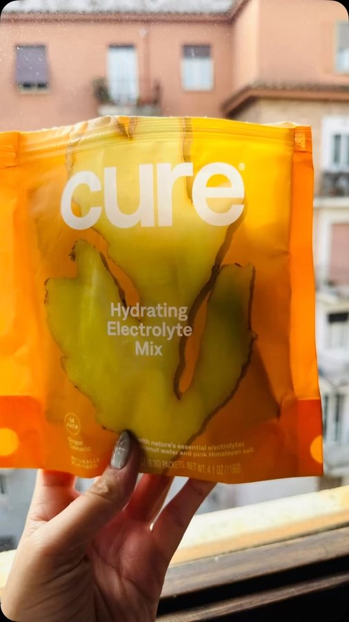 Instagram post by @healthymouth_healthylife for Cure Hydration. Caption reads: I take Cure with me wherever I go, and I even had....