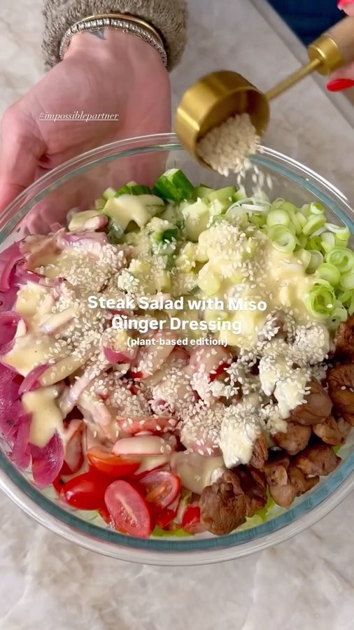 Instagram post by @kalejunkie for Impossible Foods. Caption reads: #ImpossiblePartner Steak Salad with Miso Ginger....
