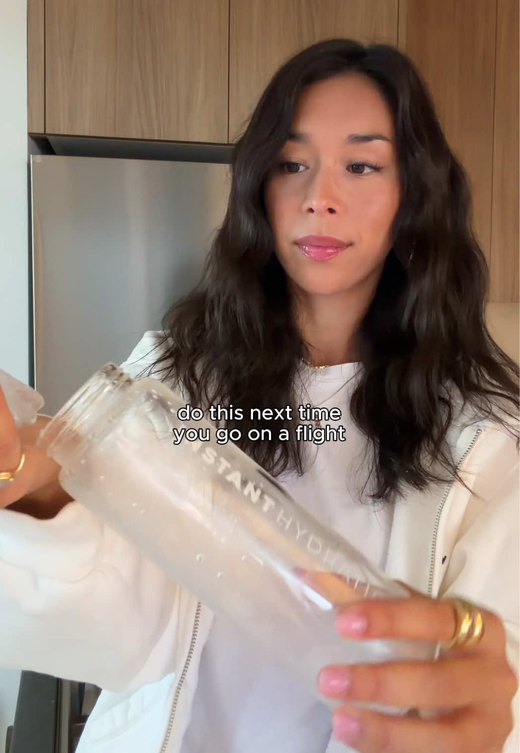 TikTok post by @laurenwolfe for Instant Hydration. Caption reads: ice through TSA + @Instant Hydration electrolytes....
