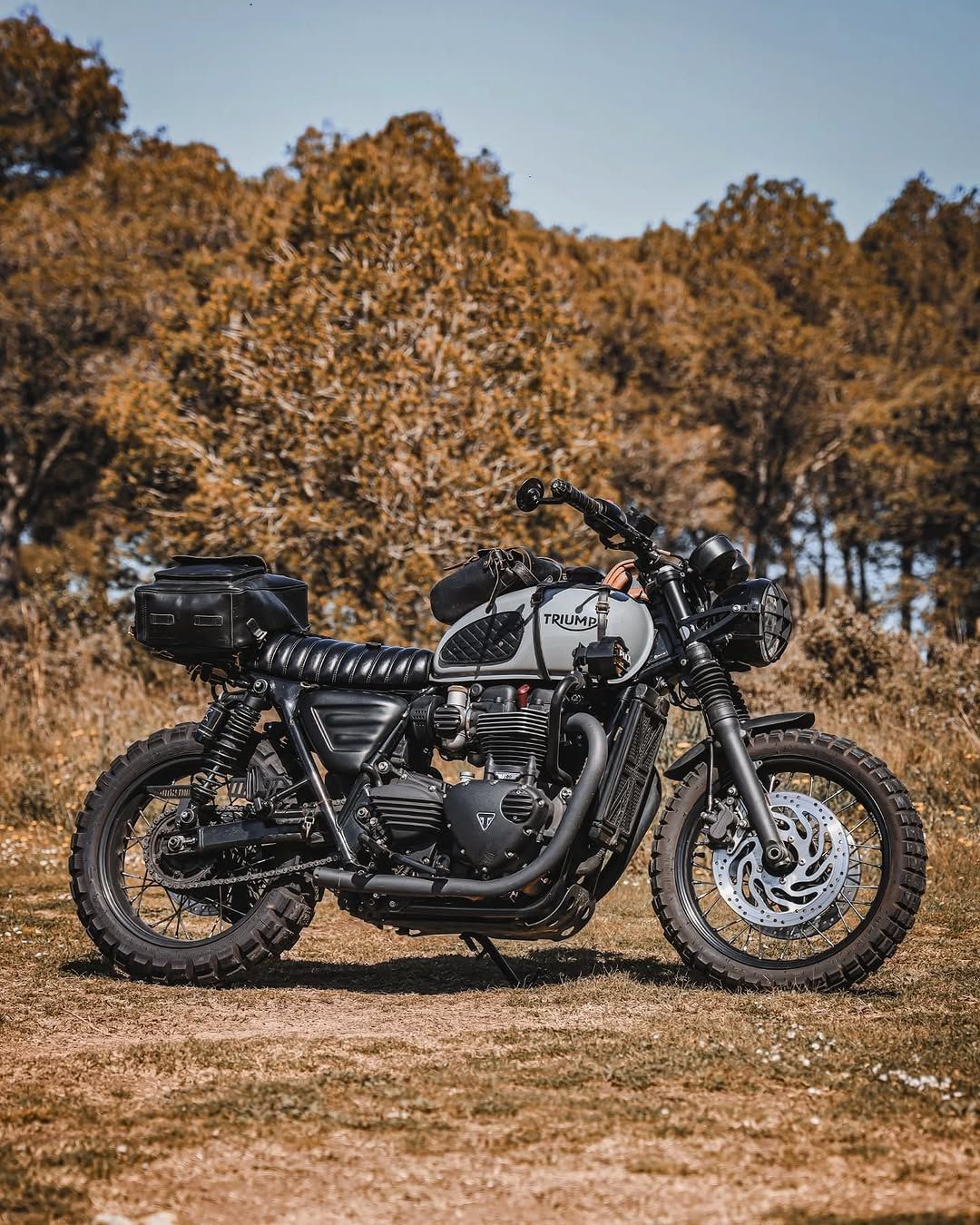 Instagram post by @bravecoastcaferacers for Triumph Motorcycles. Caption reads: The Triumph T120 turns any trail into an adventure....