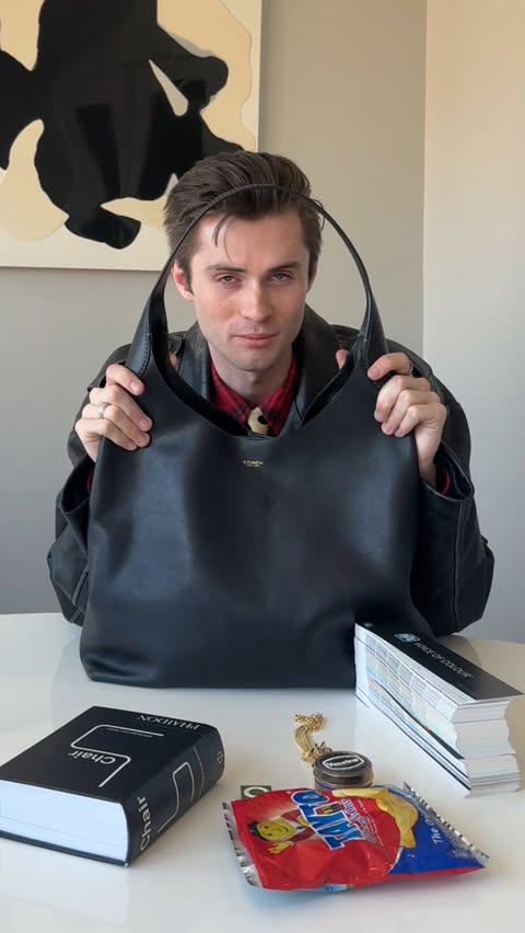 Instagram post by @dylkelly for Coach. Caption reads: what’s in my @coach brooklyn bag 👀 #ad.