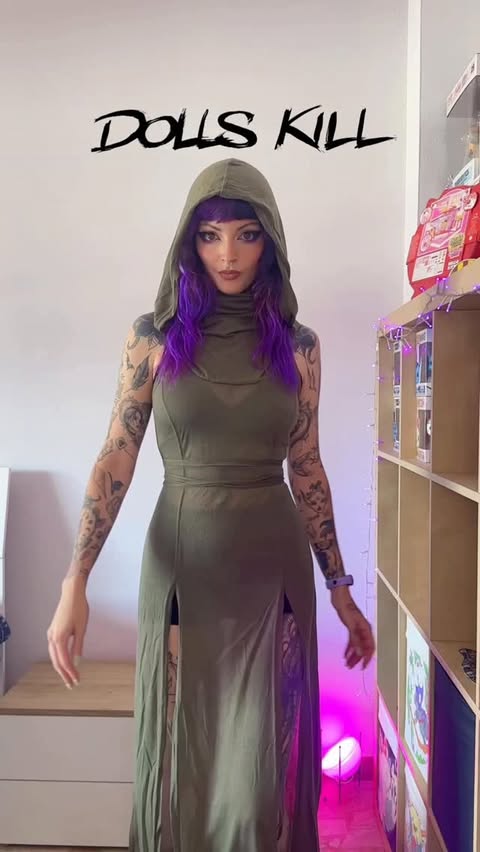 Instagram post by @strega_salamander for Dolls Kill. Caption reads: Quale outfit preferite? 💜 #giftedby @dollskill.