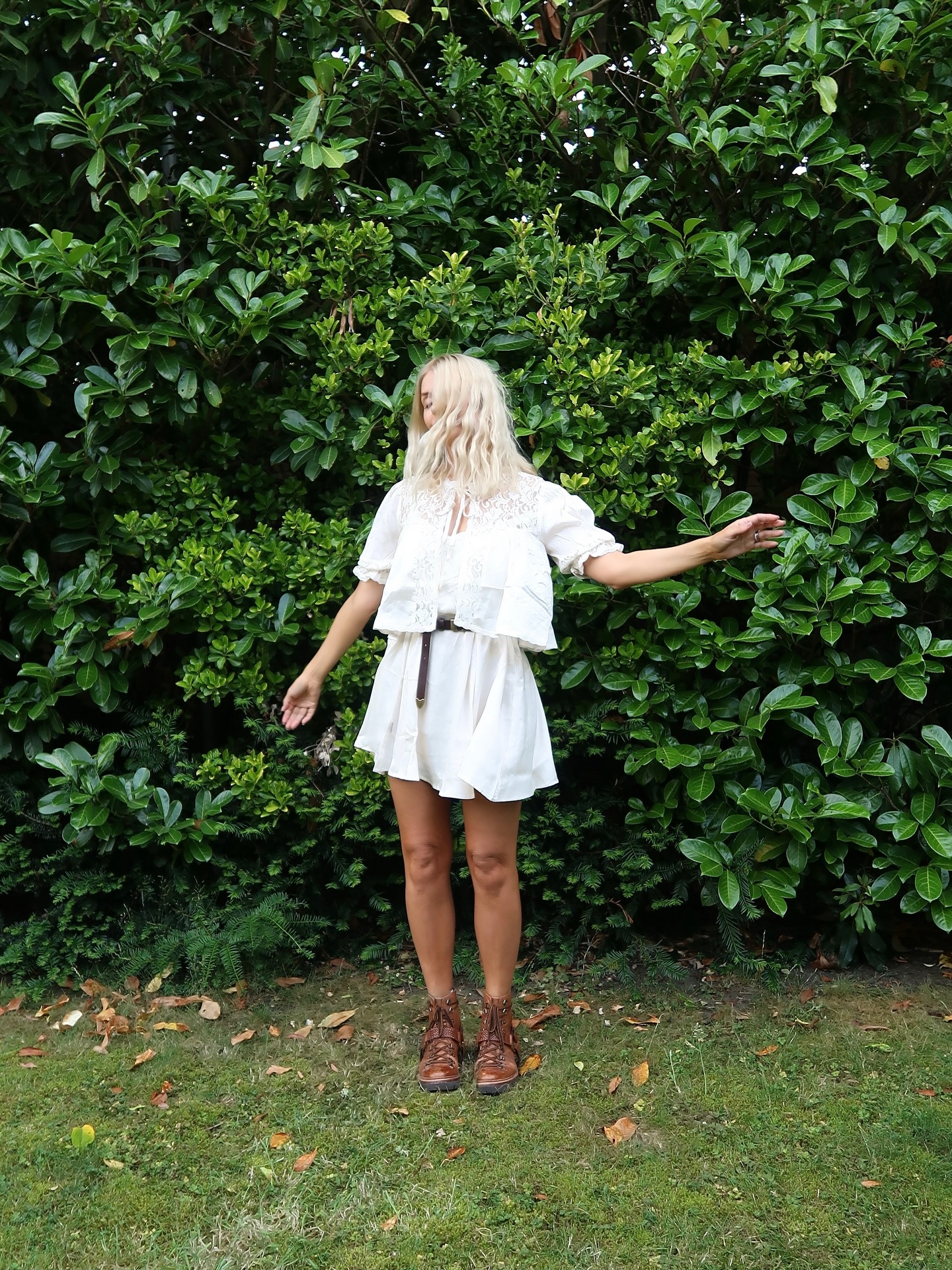 Instagram post by @hollywilloughby for Free People. Caption reads: Day 1 @glastofest #hwstyle💁🏼‍♀️✨ Dress and Belt....
