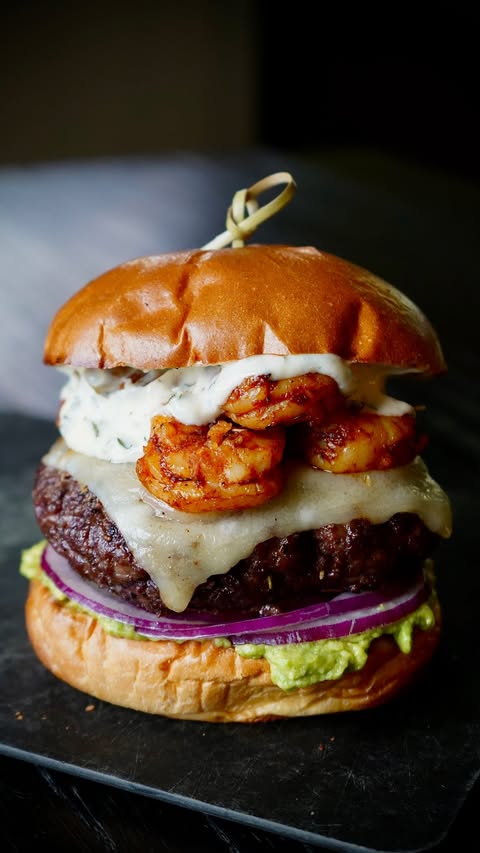 Instagram post by @calwillcookit for Sprouts Farmers Market. Caption reads: #ad Surf & Turf Burgers 🍔🦐🔥 These burgers came....