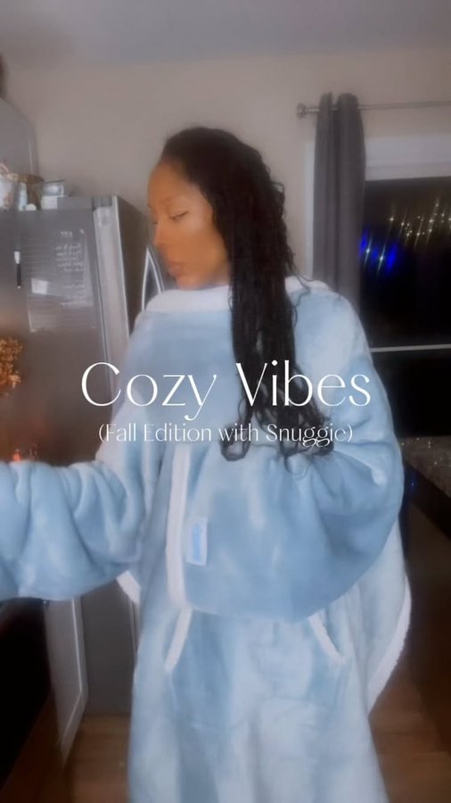 Instagram post by @iamakishajenee for Snuggie. Caption reads: [...] stay cozy, stay vibin’ with @officialsnuggie....