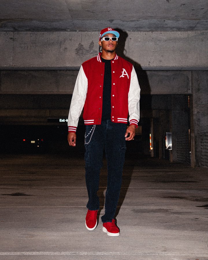 Instagram post by @taylengreen for Homefield Apparel. Caption reads: new @homefieldapparel Varsity Jacket is a must....