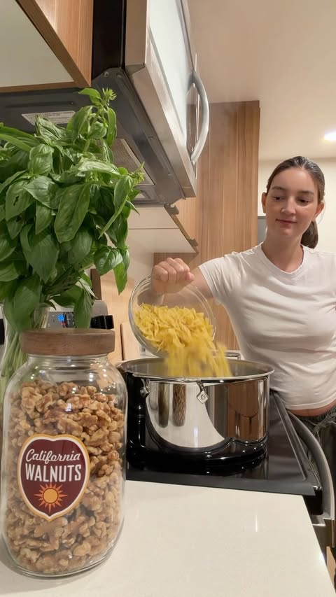 Instagram post by @emilymariko for California Walnuts. Caption reads: This walnut pesto pasta salad is my perfect summer....