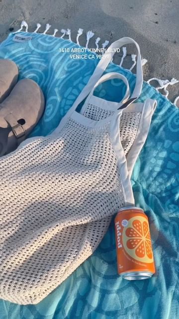 Instagram post by @erikascrublife for Sand Cloud. Caption reads: Come with me to the grand opening of @sandcloud in....