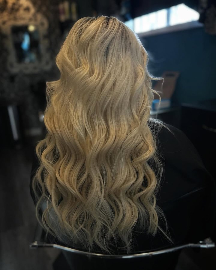 Instagram post by @michellezabattathestylist for Christian Michael Hair Extensions. Caption reads: WHAT’S UNDER THE HOOD!?🪡✨ two rows of machine....