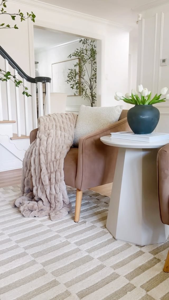 Instagram post by @meggieferrerhome for Battilo Home. Caption reads: Living room vibes with the coziest [gifted] throw....