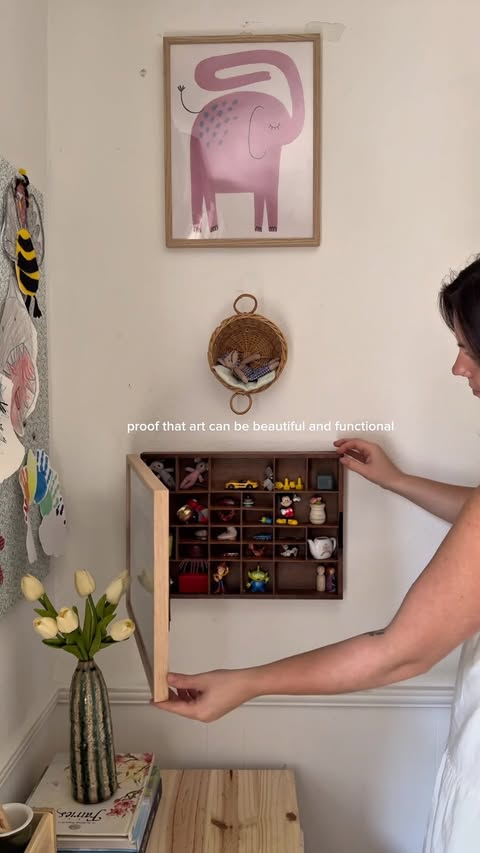 Instagram post by @ourlittlebluehomestead for Desenio. Caption reads: [...] nicknack shelf & the hidden tv behind....