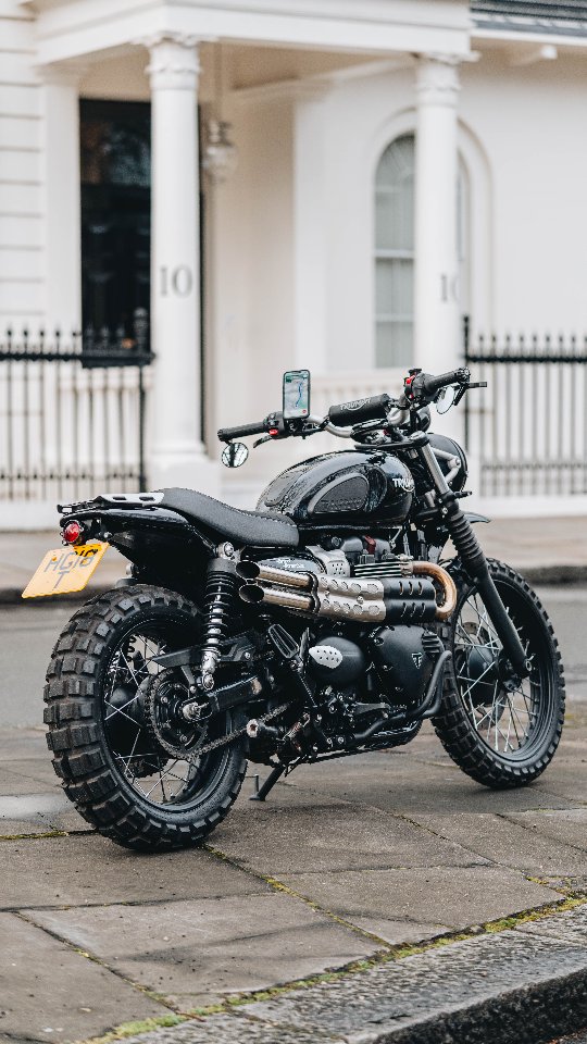 Instagram post by @caferacerdotcom for Motone. Caption reads: Triumph Scrambler 🇬🇧
-
👇 Out Now Available....
