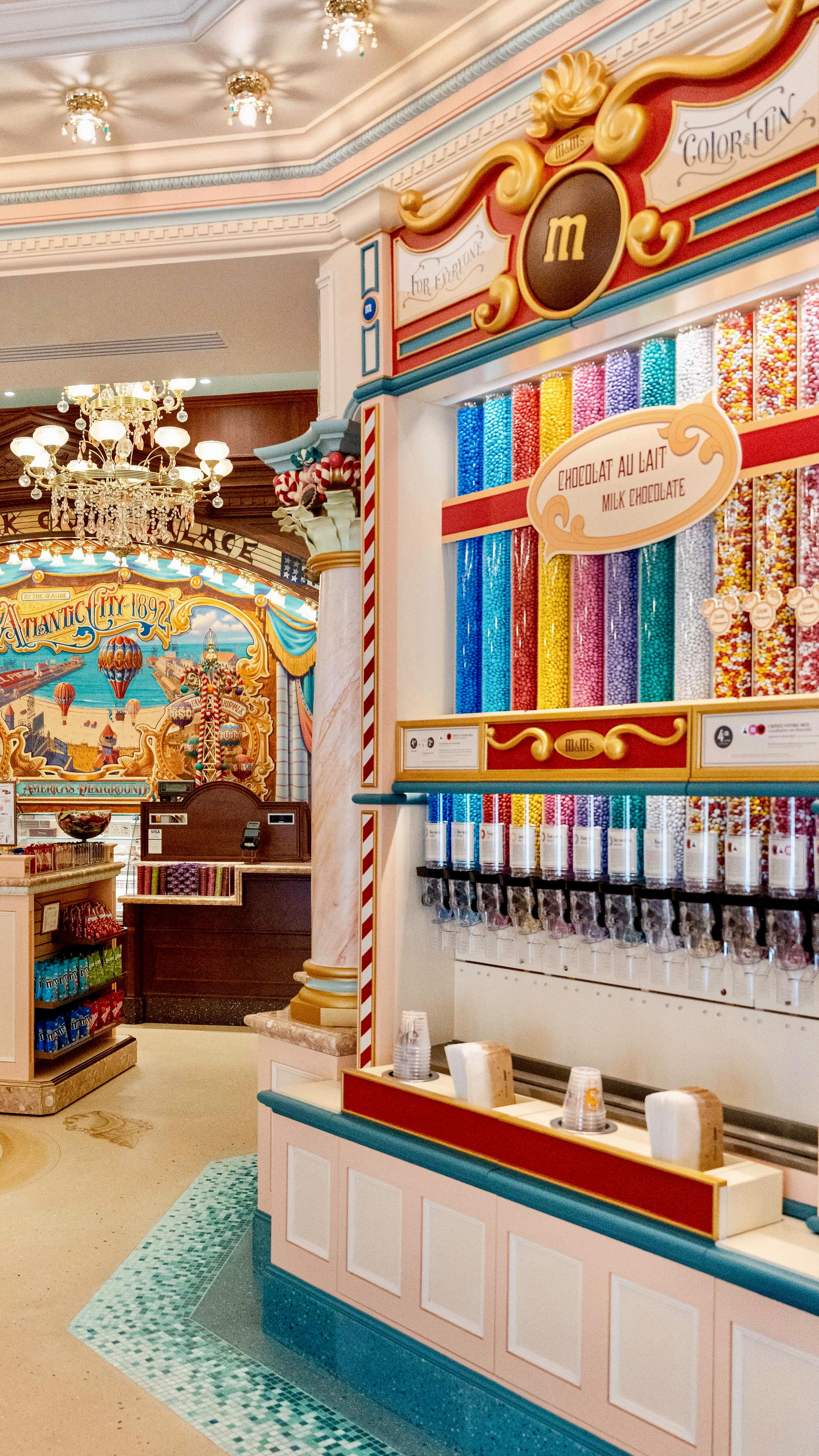 Instagram post by @disneylandparishopping for Disneyland Paris. Caption reads: Entrez dans Boardwalk Candy Palace pour découvrir....