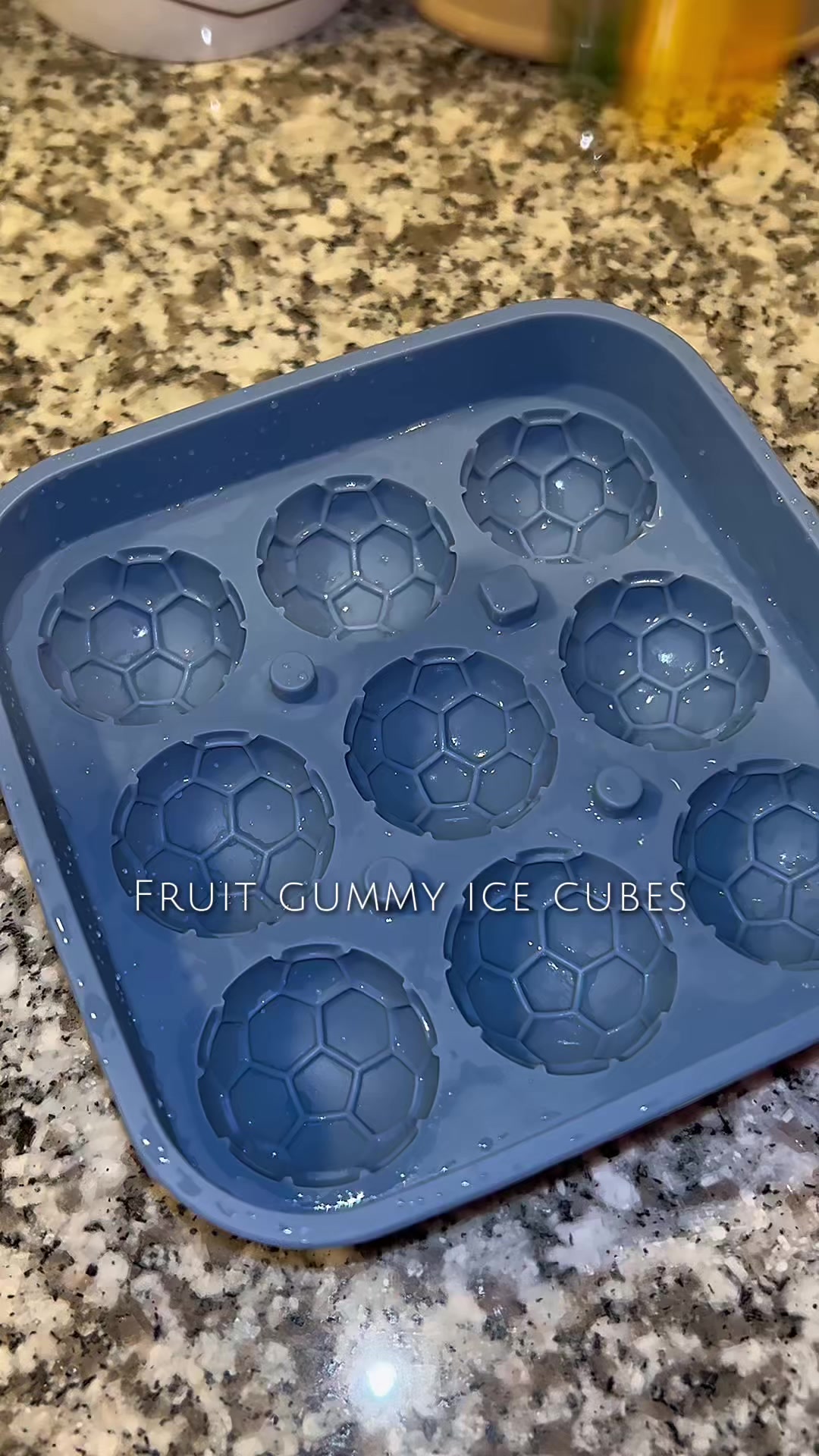 TikTok post by @katieskitchenasmr for Amos Sweets. Caption reads: [...] soccer ball-shaped ice molds 🧊⚽️ 4D @Amos....