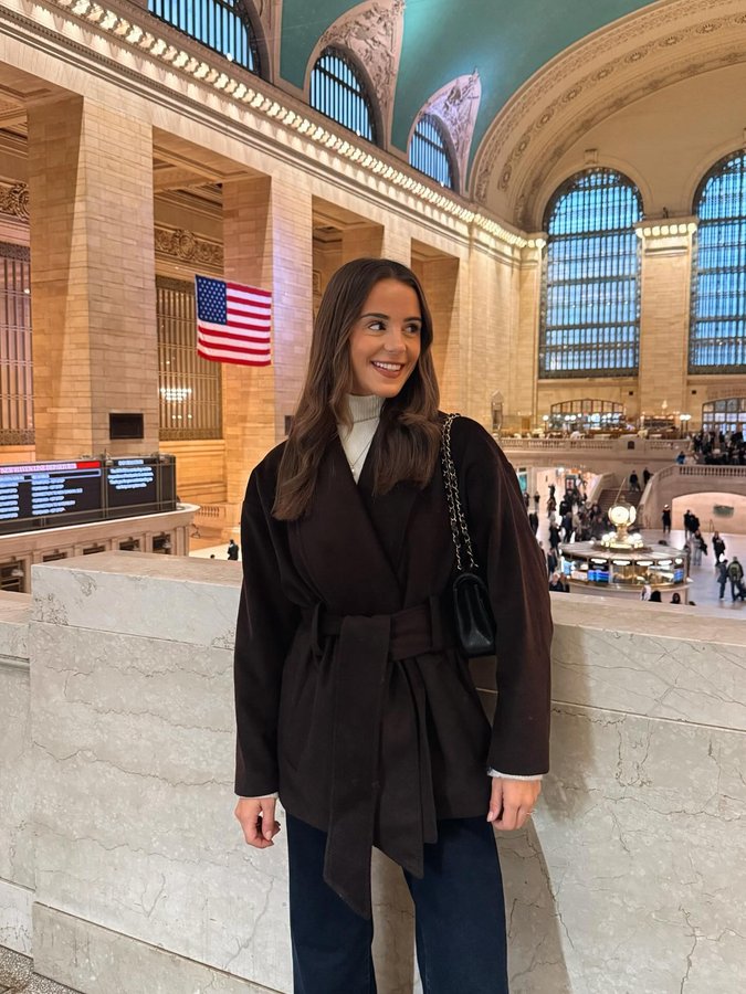 Instagram post by @whatemwore for Karen Millen. Caption reads: a dream day in NYC!!! 🚕🥂🎭.