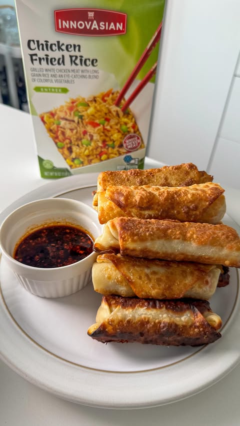 Instagram post by @happyandfull_ for InnovAsian Cuisine. Caption reads: Chicken fried rice crispy EGG ROLLS Slam dunking....