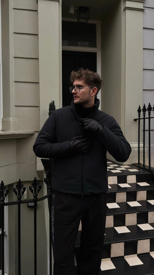 Instagram post by @niklinio for Save The Duck. Caption reads: when in doubt, go all black and cozy up with the....