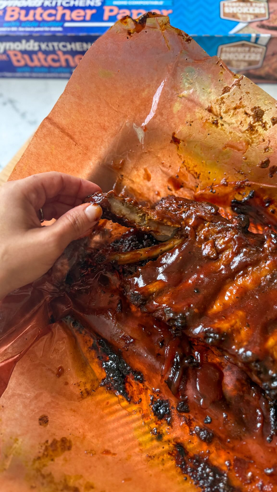 Instagram post by @kelseynixon for Reynolds Brands. Caption reads: #ad The secret to THE BEST oven roasted ribs is....