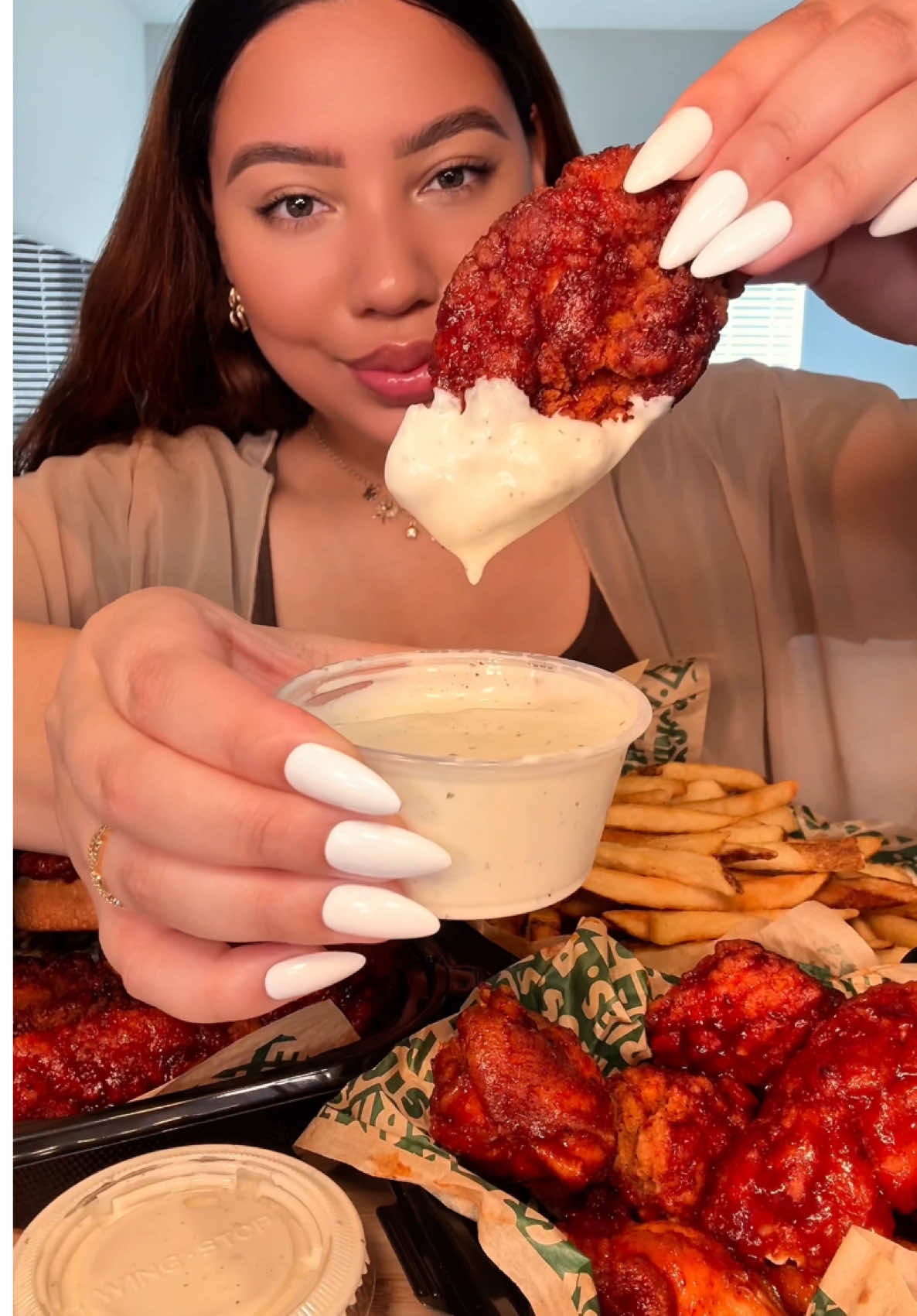 TikTok post by @claudiaeatsgood for Wingstop. Caption reads: 🔥🥰 this fiery lime flavor from @Wingstop is....