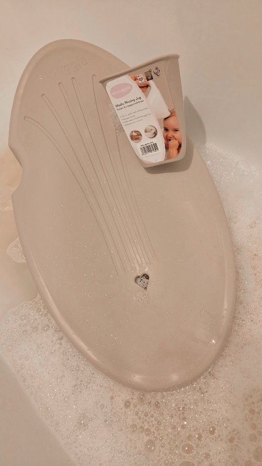 Instagram post by @the.waldron.family for Shnuggle. Caption reads: AD | @shnuggle Bathtime made easier with the....