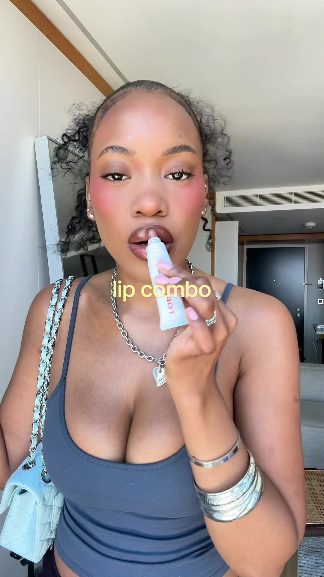 TikTok post by @mikaimcdermott for TOPICALS. Caption reads: really chic warm nude lip combo @TOPICALS slick....