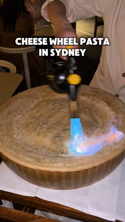 Instagram post by @sydneybestfeeds for Sydney's Food Scene. Caption reads: SIGNATURE FLAMING CHEESE PASTA 🍝🔥 📍Rovollo (4.7....