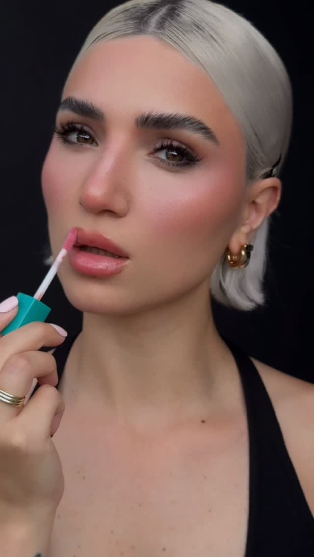 Instagram post by @aitan.akhmed for Thrive Causemetics. Caption reads: Obsessed with this glossy shine 💋✨ Wearing....