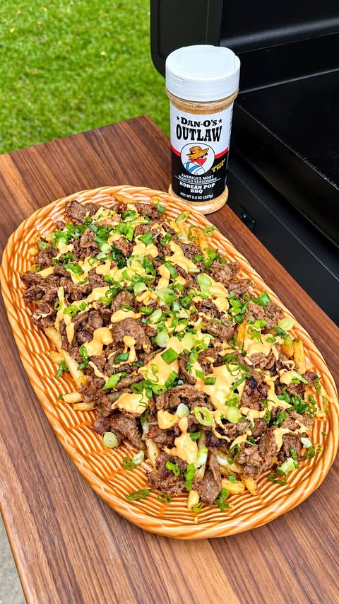 Instagram post by @johnandchelseahome for Dan-O's Seasoning. Caption reads: [...] loaded fries for dinner! I used....