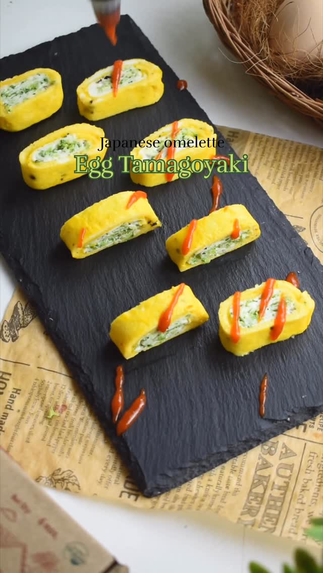 Instagram post by @flavours_of_wok_ for Akshayakalpa Organic. Caption reads: 🌿🍳 Double Colour Tamagoyaki – soft, fluffy, and....