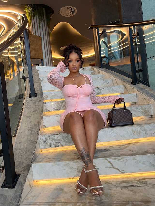 Instagram post by @ntombi__mbele for Fashion Nova. Caption reads: Pink affair 🌸 @FashionNova 🔎 “Emilina Long....