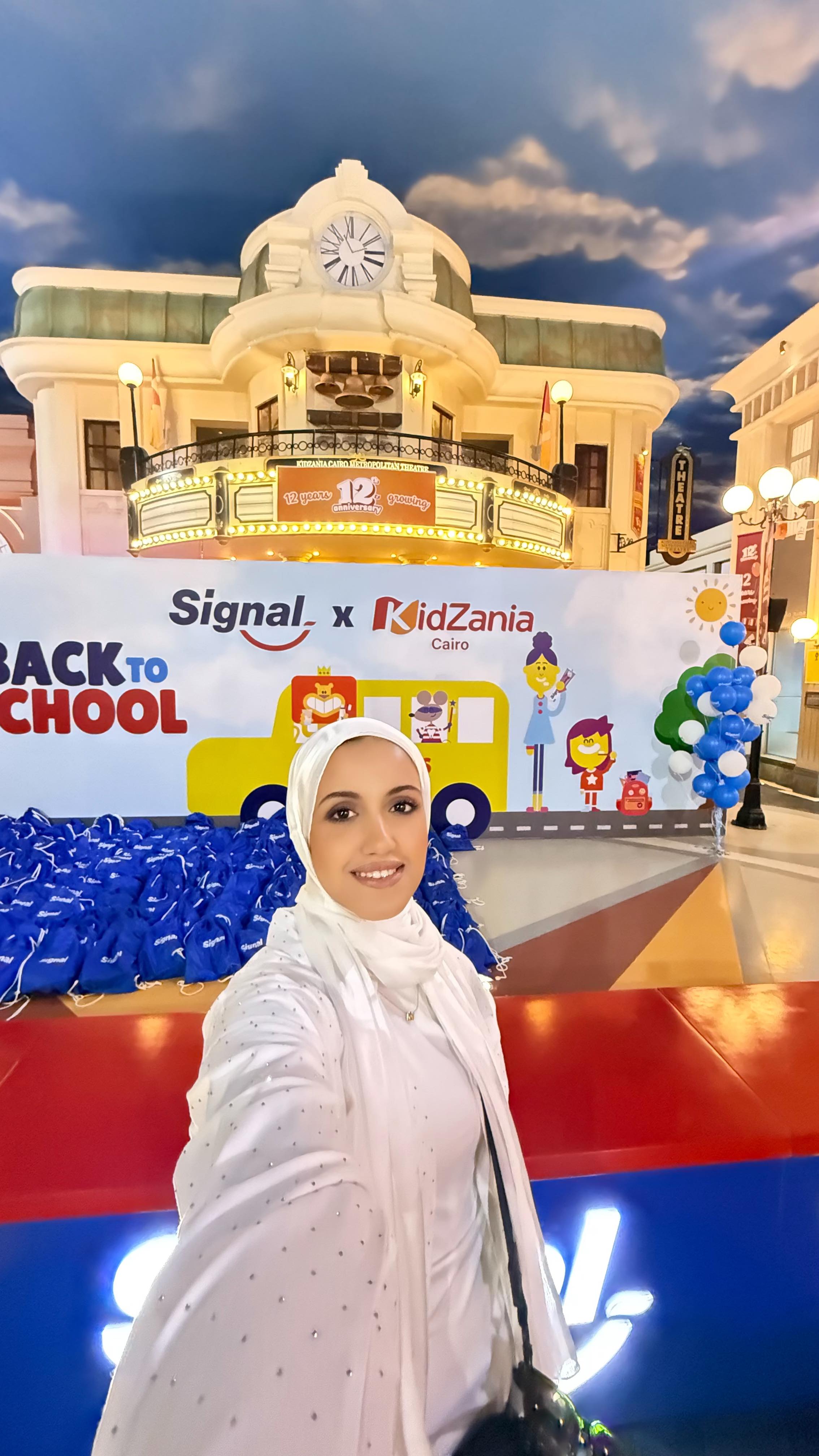 Instagram post by @maiahmad_official for KidZania. Caption reads: [...] all the smiles 📚🎒🦷💙 @signalegypt....