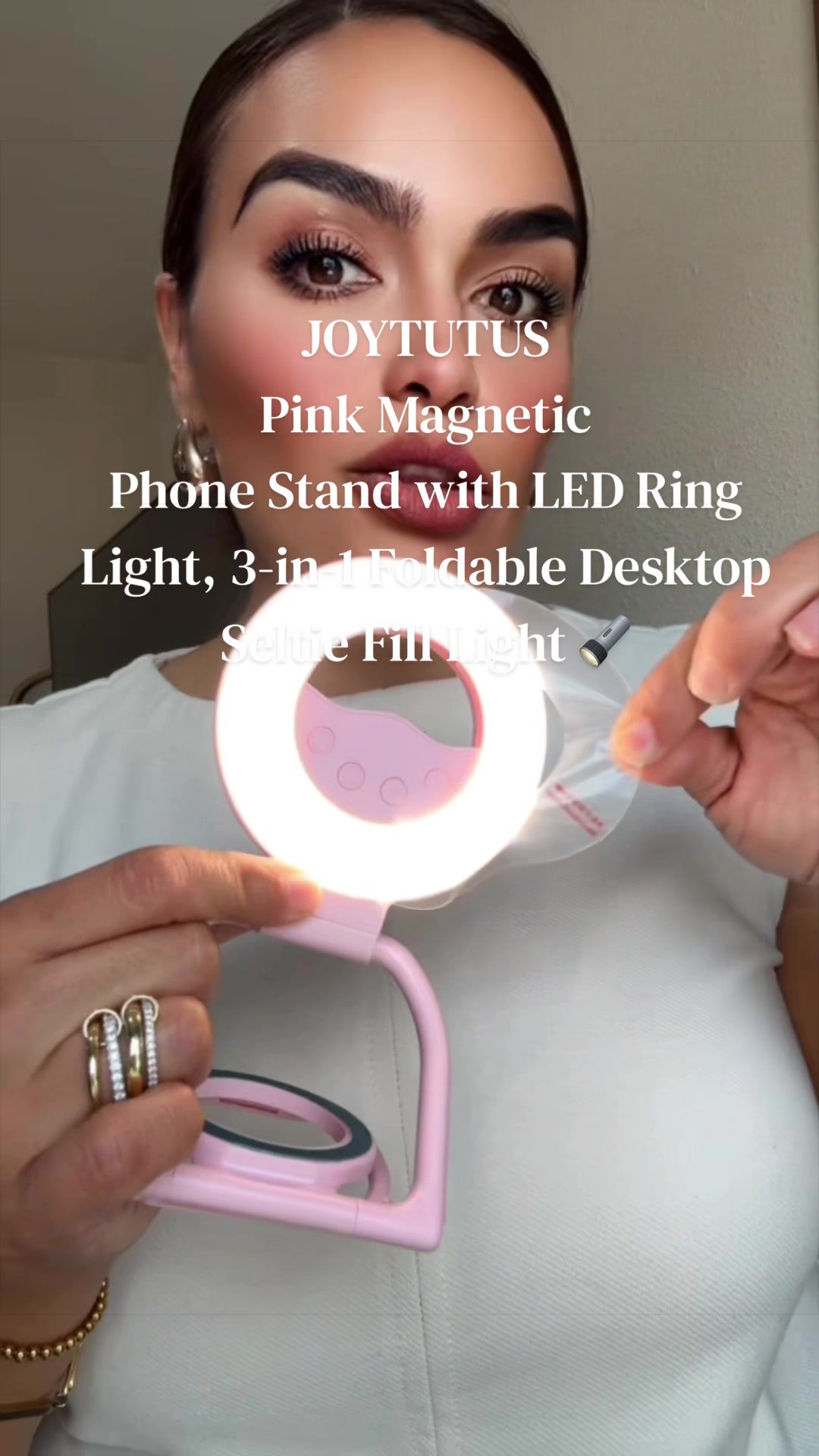 TikTok post by @lauarizaga677 for JoyTutus. Caption reads: JOYTUTUS Pink Magnetic Phone Stand with LED Ring....