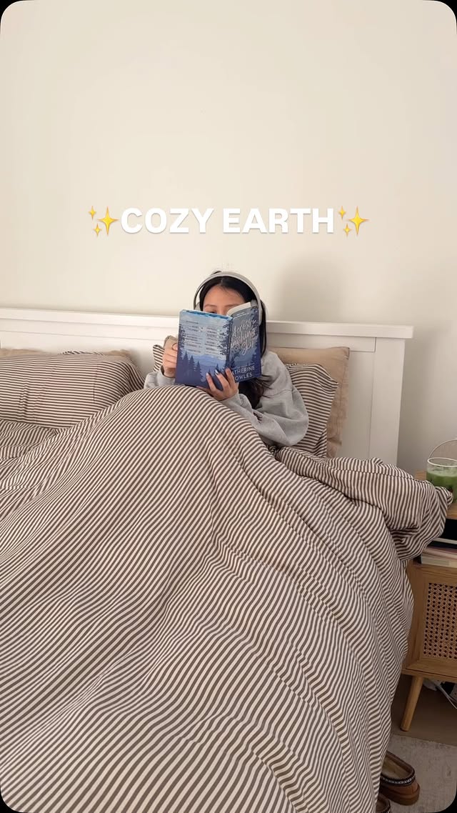 Instagram post by @bookthaography for COZY EARTH. Caption reads: cozy day with @cozyearth ☁️🧸📖 literally no....