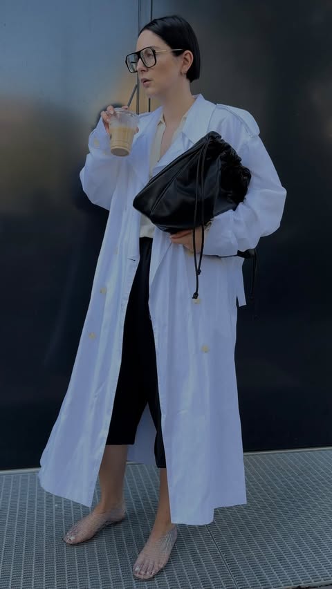 Instagram post by @fashionstylistmb for The Row. Caption reads: ad/werbung doubled-breasted trench coat love 🥼.