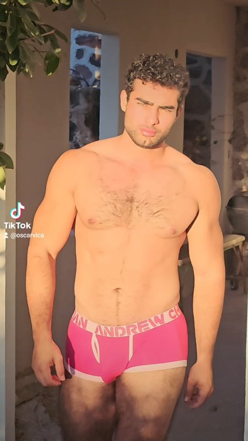 Instagram post by @oscar_vica for Andrew Christian. Caption reads: [...] usando el código:....