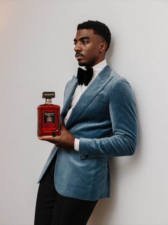 Instagram post by @mrderrickbrownie for Disaronno. Caption reads: Matching my drink with my outfit. 🤵🏾‍♂️

I’m....