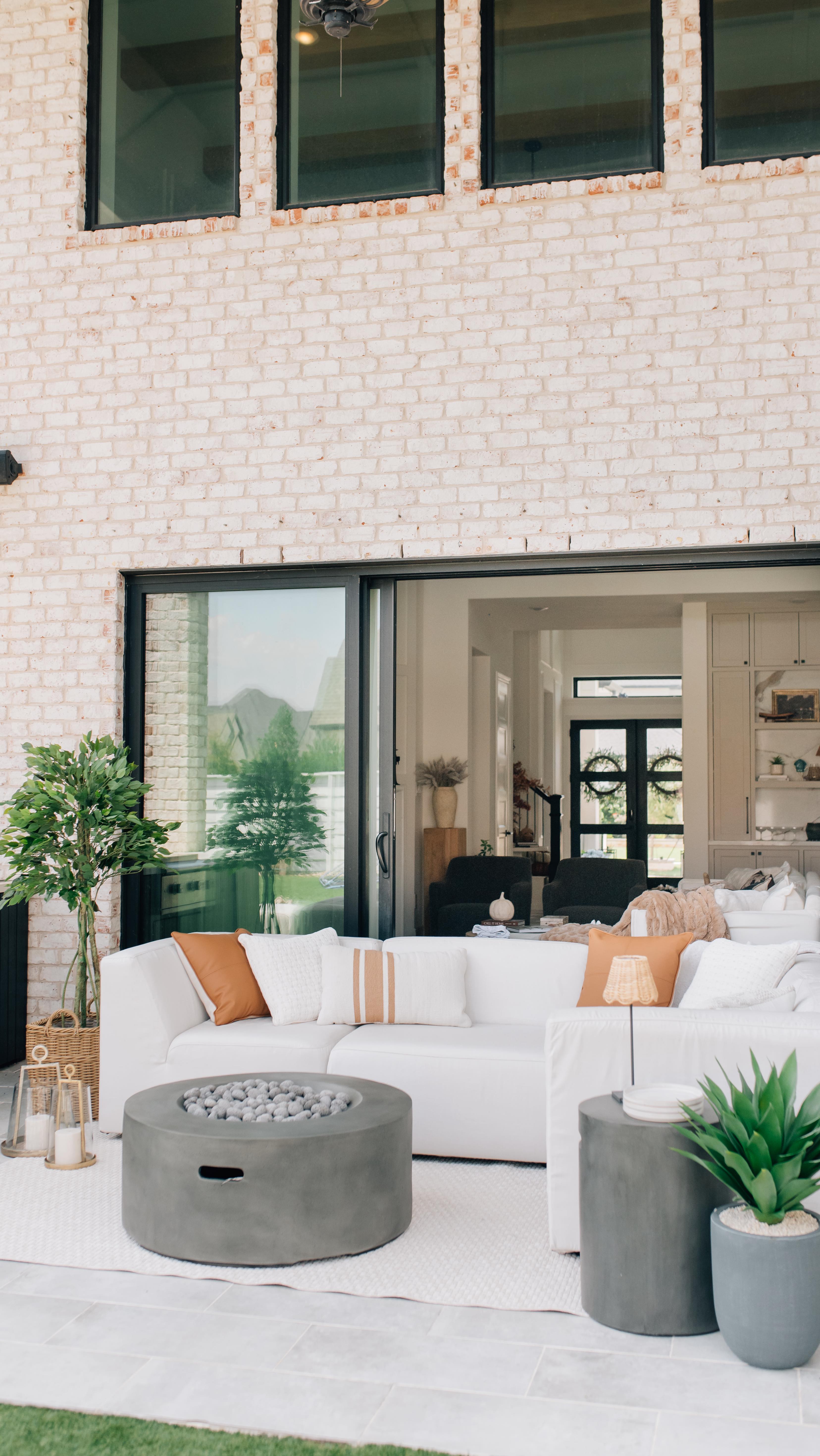 Instagram post by @anniemescallhome for Rooms To Go. Caption reads: Welcome to our backyard patio! ☀️ Cooler weather....