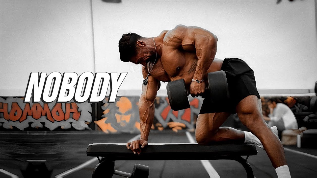 YouTube post by @MuscleBrawn for ENHANCED Labs. Caption reads: 𝗡𝗢𝗕𝗢𝗗𝗬 𝗖𝗔𝗡 𝗦𝗧𝗢𝗣 𝗬𝗢𝗨 😎 𝗚𝗬𝗠....