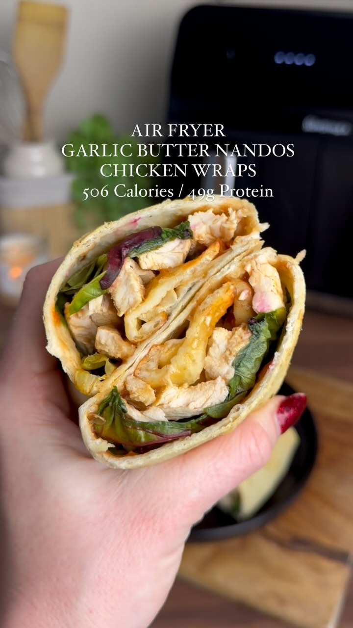Instagram post by @slimming.gym.and.gin for MyFitnessPal. Caption reads: RECIPE IN CAPTION ⬇️ 

NANDOS GARLIC BUTTER WRAP....