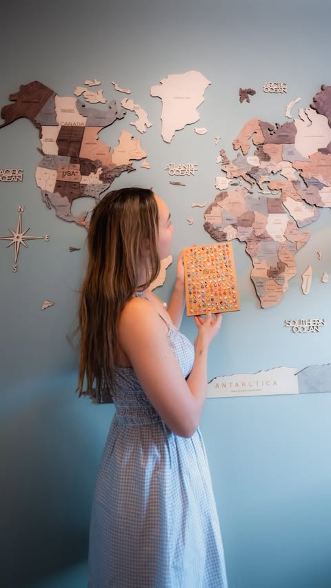 Instagram post by @nextstopwithjulie for Enjoy The Wood. Caption reads: [...] this wooden world map from @enjoythewood_ is....