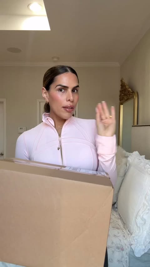 Instagram post by @ninayrigoyen for Naked Wardrobe. Caption reads: Unboxing my new winter coat from @nakedwardrobe 🖤....