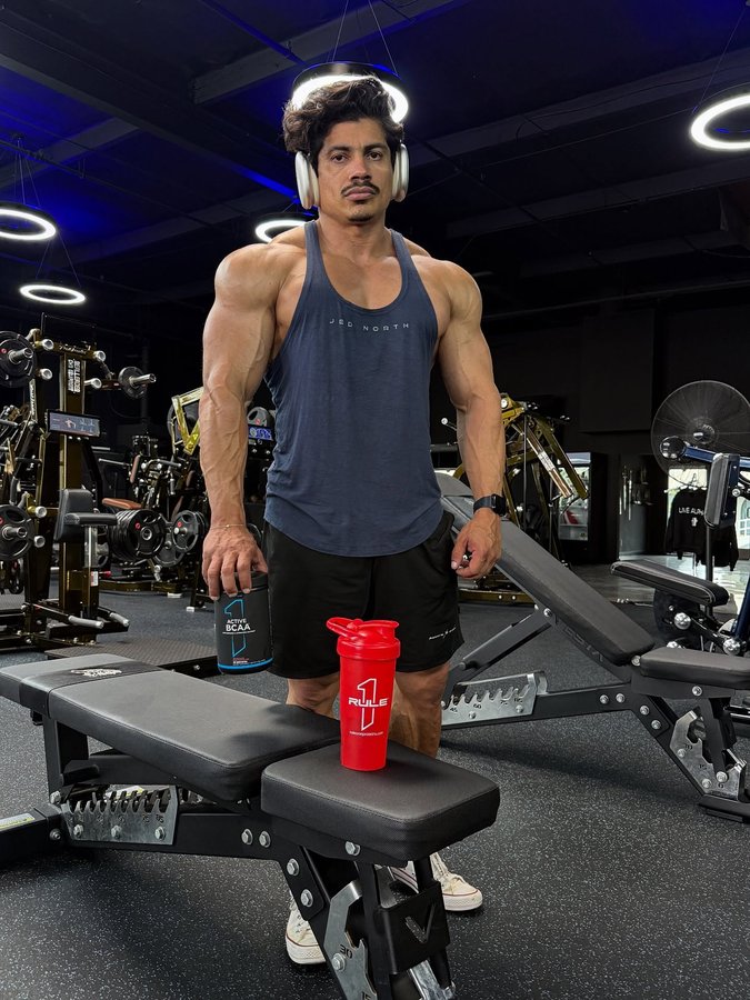 Instagram post by @dinoestrada14 for Rule One Proteins. Caption reads: Shoulder workout! Fueled by @ruleoneproteins....