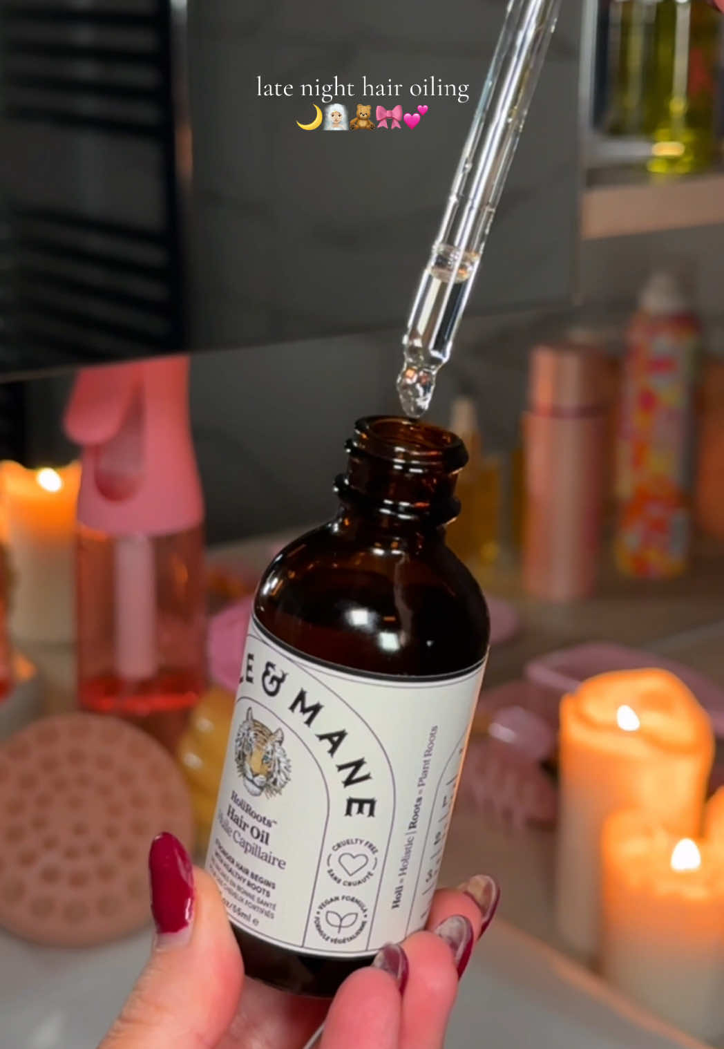 TikTok post by @by.emmaleah for Fable and Mane. Caption reads: [...] & Mane holiroots hair oil* @fableandmane....