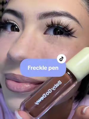 TikTok post by @realsilvana for Babygodewy Beauty. Caption reads: [...] #freckles #freckpen #makeup #grwm....