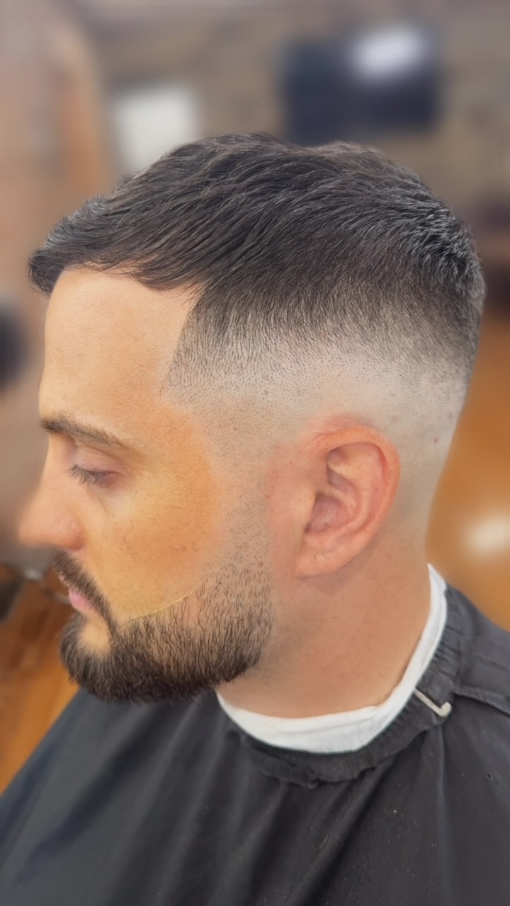 Instagram post by @jake_thebarber1 for Barbershopconnect. Caption reads: High/mid skin fade using @heinigerprofessionals....